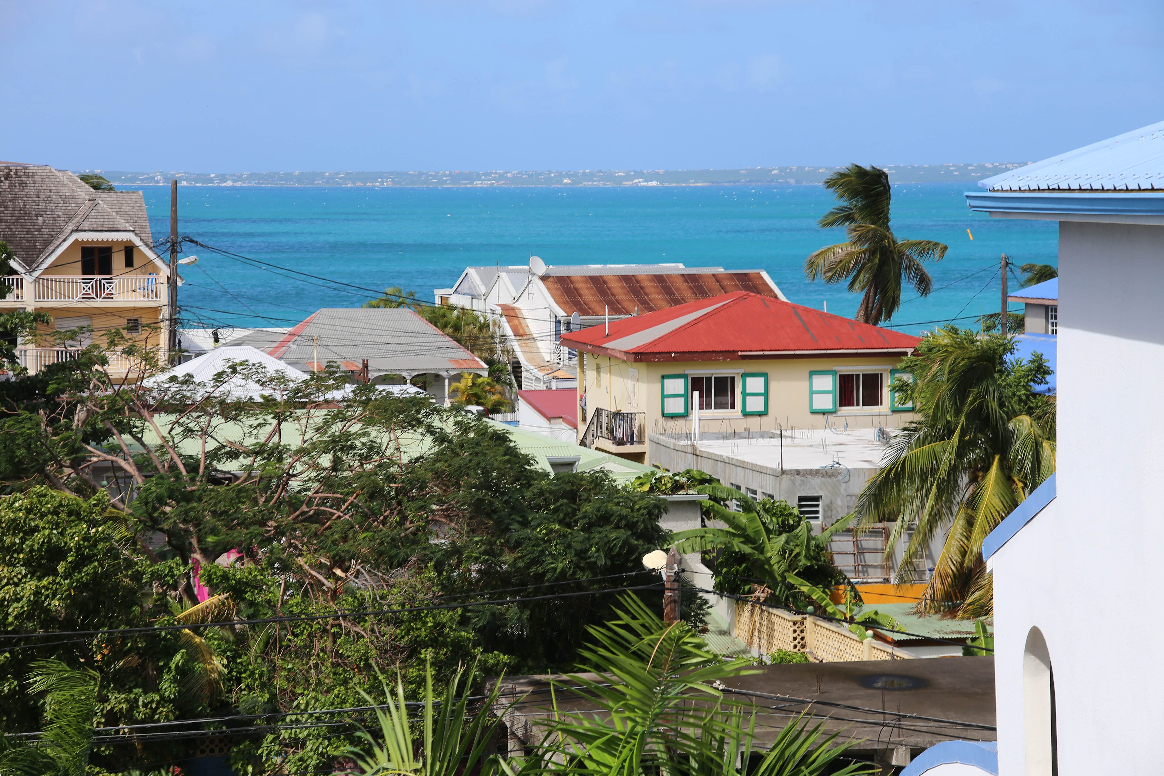 Creole rooftops of Grand Case village against the turquoise bay, Saint-Martin